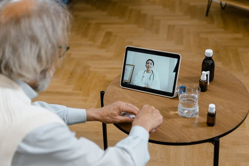 old man watching on tablet