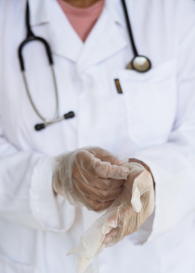 Médico poniendose guantes