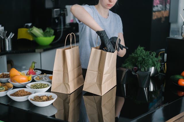 Chica mete boles de comida en una bolsa